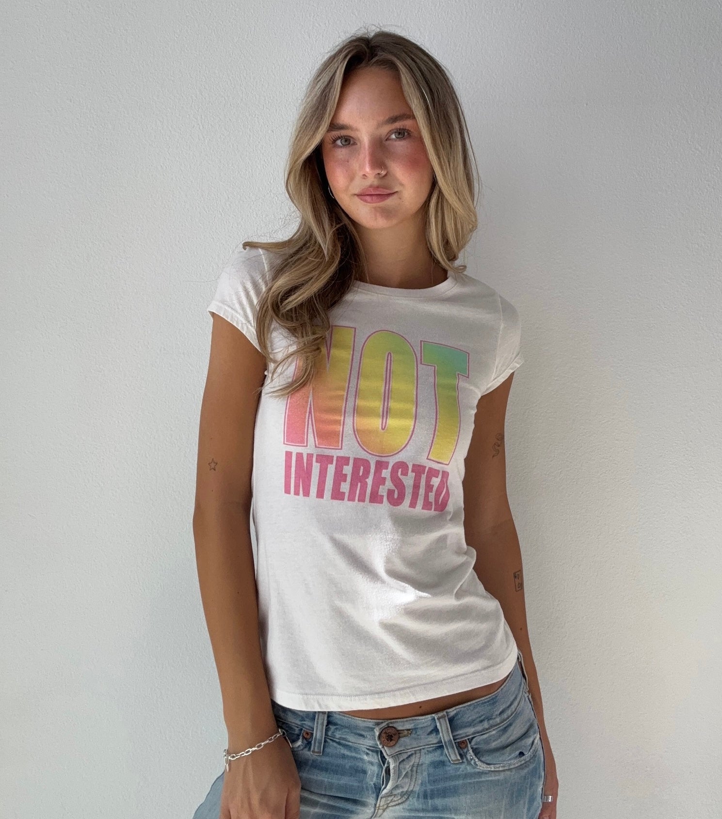 “Not Interested” Graphic Baby Tee (Small)